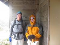 Greg and Lee take shelter on the summit.